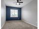 Carpeted bedroom features a ceiling fan and a large window providing natural light at 4451 S Ammons St # 2-204, Littleton, CO 80123