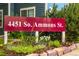 Community sign displaying 4451 So. Ammons St. with beautiful landscaping and rocks at 4451 S Ammons St # 2-204, Littleton, CO 80123