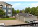 View of complex building with assigned parking garage, greenery, and a basketball hoop at 4451 S Ammons St # 2-204, Littleton, CO 80123