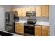 Modern kitchen with stainless steel appliances, light wood cabinets, and bright countertops at 4451 S Ammons St # 2-204, Littleton, CO 80123