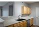 Kitchen featuring wood cabinets, stainless steel sink and dishwasher, and spacious countertops at 4451 S Ammons St # 2-204, Littleton, CO 80123