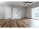 Bright living room featuring hardwood floors, neutral walls, and sliding door to balcony at 4451 S Ammons St # 2-204, Littleton, CO 80123
