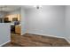 Neutral living room with stylish lighting fixtures, hardwood floors, and access to kitchen at 4451 S Ammons St # 2-204, Littleton, CO 80123