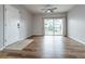 Open-concept living space features stylish flooring, balcony access, and a contemporary ceiling fan at 4451 S Ammons St # 2-204, Littleton, CO 80123