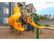 Community playground with colorful slides, climbing structures, and a picnic area at 4451 S Ammons St # 2-204, Littleton, CO 80123