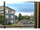 View through a window of an exterior of blue townhomes at 4451 S Ammons St # 2-204, Littleton, CO 80123