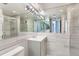Modern bathroom featuring a sleek vanity, tiled walls, and a glass-enclosed shower, reflecting minimalist design at 3100 E Cherry Creek South Dr # 1101, Denver, CO 80209