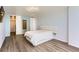 Well-lit bedroom with hardwood floors, a modern ceiling fan, and a view to the bathroom at 3100 E Cherry Creek South Dr # 1101, Denver, CO 80209
