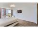 Bright bedroom featuring hardwood floors, large windows with city views, and a modern ceiling fan at 3100 E Cherry Creek South Dr # 1101, Denver, CO 80209