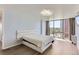 Spacious bedroom featuring hardwood floors, large windows with city views, and a modern platform bed at 3100 E Cherry Creek South Dr # 1101, Denver, CO 80209