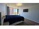 Serene bedroom with large windows offering city views and a modern ceiling fan at 3100 E Cherry Creek South Dr # 1101, Denver, CO 80209