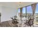 Dining area features a modern chandelier, glass table, and scenic views from large windows at 3100 E Cherry Creek South Dr # 1101, Denver, CO 80209