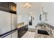 Well-lit kitchen with stainless steel appliances, granite countertops, stylish cabinetry, and tiled flooring at 3100 E Cherry Creek South Dr # 1101, Denver, CO 80209