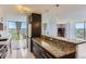 Modern kitchen boasts granite counters, black appliances, and a seamless open layout at 3100 E Cherry Creek South Dr # 1101, Denver, CO 80209