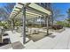 Outdoor dining space featuring tables, chairs, a pergola, and lush landscaping at 3100 E Cherry Creek South Dr # 1101, Denver, CO 80209