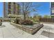 Well-maintained outdoor patio area with a pergola, planters, and building in the background at 3100 E Cherry Creek South Dr # 1101, Denver, CO 80209