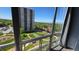 Scenic view from condo's window overlooking a green space with buildings and mountains in the distance at 3100 E Cherry Creek South Dr # 1101, Denver, CO 80209