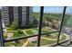 Beautiful window view of a well-manicured lawn, gazebo, and tennis court in a high-rise community at 3100 E Cherry Creek South Dr # 1101, Denver, CO 80209