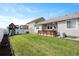 Large, well-maintained backyard with a green lawn and wooden play set at 2200 Cadman St, Berthoud, CO 80513