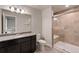 Well-lit bathroom with granite countertops, a dark wood vanity, and a tiled walk-in shower at 2200 Cadman St, Berthoud, CO 80513