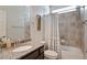 Well-lit bathroom featuring a shower-tub combo, granite countertop and a modern vanity at 2200 Cadman St, Berthoud, CO 80513