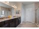 Bathroom features dark cabinets, double sink vanity with granite countertop and walk-in shower at 2200 Cadman St, Berthoud, CO 80513