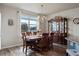 Dining room features a large window, chandelier, and dark wood dining table and china cabinet at 2200 Cadman St, Berthoud, CO 80513