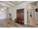 Inviting entryway with wood floors, hall tree, and views into other living spaces at 2200 Cadman St, Berthoud, CO 80513