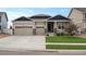 Charming home with a three-car garage, well-maintained lawn, and stone column accents at 2200 Cadman St, Berthoud, CO 80513