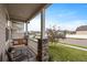 Cozy front porch showcasing a porch swing and stone pillar posts at 2200 Cadman St, Berthoud, CO 80513
