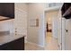 Bright hallway featuring tile flooring, white doors, and an open doorway to a closet at 2200 Cadman St, Berthoud, CO 80513