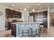 Kitchen features dark cabinets, granite countertops, stainless appliances, and center island with barstool seating at 2200 Cadman St, Berthoud, CO 80513