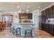 Spacious kitchen features dark cabinets, a center island with seating and pendant lighting at 2200 Cadman St, Berthoud, CO 80513