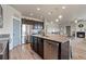 Bright open kitchen features dark cabinets, stainless appliances, and center island with built-in sink at 2200 Cadman St, Berthoud, CO 80513