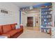 Bright living room with a cozy sofa and built-in bookshelves adjacent to an entryway at 2200 Cadman St, Berthoud, CO 80513