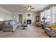 Spacious living room with neutral carpet, fireplace, and ample natural light from the windows at 2200 Cadman St, Berthoud, CO 80513