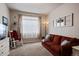 Comfortable living room featuring a sitting area, a large window and neutral decor at 2200 Cadman St, Berthoud, CO 80513