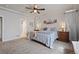 Bright main bedroom features a ceiling fan, carpet, neutral walls, with an ensuite bathroom at 2200 Cadman St, Berthoud, CO 80513