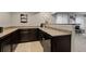 Basement wet bar area featuring dark cabinetry, granite countertops, and tile flooring at 2200 Cadman St, Berthoud, CO 80513