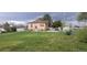 Backyard view of brick home with well-maintained lawn and perimeter metal fence at 9120 Elm Ct, Denver, CO 80260