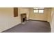 A finished basement with a brick fireplace and neutral-colored carpet at 9120 Elm Ct, Denver, CO 80260