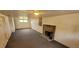A finished basement with a brick fireplace, carpet flooring, and white walls at 9120 Elm Ct, Denver, CO 80260