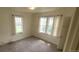 Light-filled bedroom with two large windows and neutral carpet at 9120 Elm Ct, Denver, CO 80260