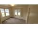Bright bedroom featuring large windows and neutral carpeting at 9120 Elm Ct, Denver, CO 80260