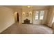 Bright living room featuring carpeted flooring, decorative fireplace, and neutral tones at 9120 Elm Ct, Denver, CO 80260