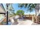 Inviting back deck with wood railings, an outdoor fireplace, and comfortable seating arrangement at 20855 Omaha Ave, Parker, CO 80138