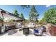 Inviting back deck featuring wood railings, an outdoor fireplace, and comfortable seating at 20855 Omaha Ave, Parker, CO 80138