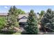 Beautiful backyard featuring mature trees, a covered patio, and a well-maintained lawn at 20855 Omaha Ave, Parker, CO 80138