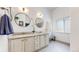 Bright bathroom featuring double sinks with granite countertops and a bench near the window at 20855 Omaha Ave, Parker, CO 80138