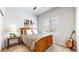 Cozy bedroom with natural light, a queen size bed, and wood flooring at 20855 Omaha Ave, Parker, CO 80138